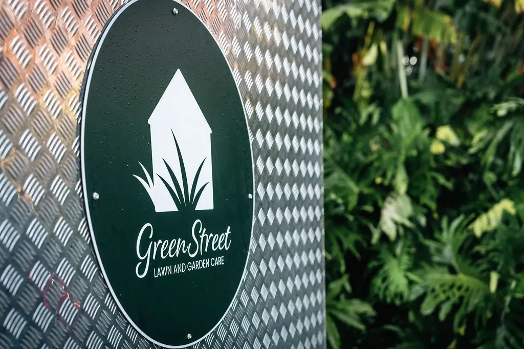 GreenStreet logo sign on the checker plate trailer beside a garden bed
